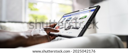 African American Holding Tablet And Shopping Online In Ecommerce Store Royalty-Free Stock Photo #2025042176