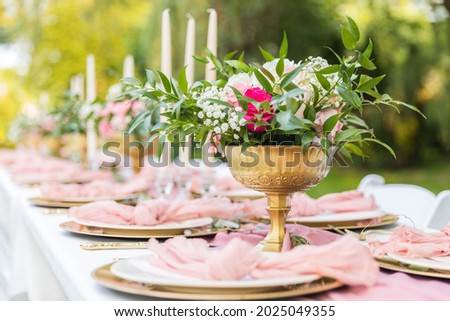
close up of fancy rose floral centerpiece for outdoor dining Royalty-Free Stock Photo #2025049355