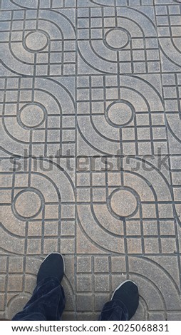 Image of a block pavement with geometric patterns. with circle patterns, wave curves and square patterns
