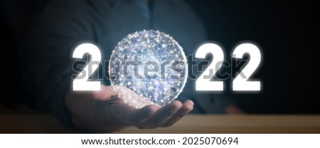 happy new year 2022 in the hand of a businessman. 2022 Technology digital style concept. 
Elements of this image furnished by NASA.

