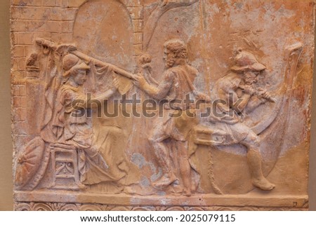 terracotta relief of Athena and Jason getting a ship ready. Historical roman art work first century Royalty-Free Stock Photo #2025079115