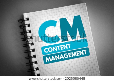 CM - Content Management is a set of processes and technologies that supports the collection, managing, and publishing of information in any form or medium, acronym concept on notepad