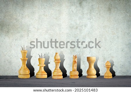 White chess pieces on the background of a concrete wall. Copy space. Strategy. Sport. Background.