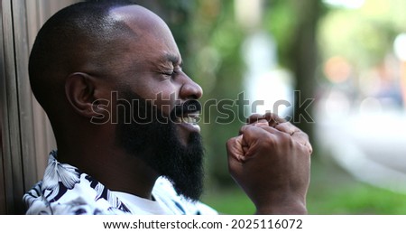 Positive African man feeling spiritual and happy. Hopeful and faithful person