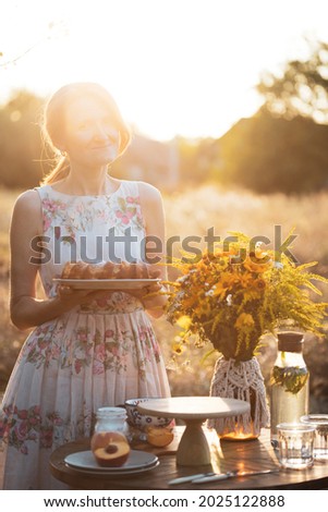 Girl in the garden with peach pie. village life
