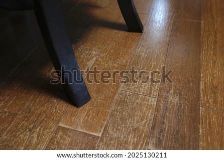 There are numerous scratches on the floor, scraped by the chair. Royalty-Free Stock Photo #2025130211