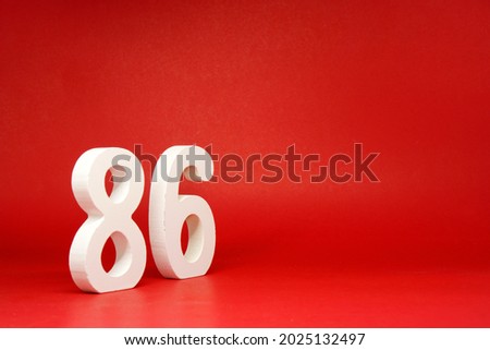 Eighty Six ( 86 ) white number wooden Isolated Red Background with Copy Space - New promotion 86% Percentage   Business finance or birthday Concept - advertise banner picture online with copy space