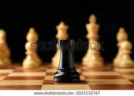 Chessboard with game pieces on black background