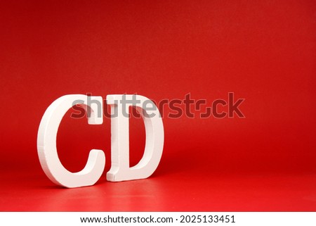 CD white letter word wooden Isolated Red Background with Copy Space - Advertise object symbol or  Education Concept      