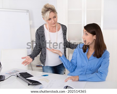 Disagreement, bullying and trouble under two business woman at work. Royalty-Free Stock Photo #202514365