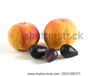 Horizontal photography with white background of two peaches and three figs from the organic garden.