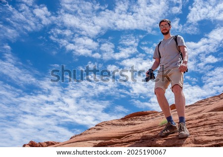 Photographer in mountains against sky