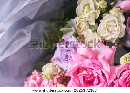 Part of a large bouquet of flowers in close-up. Large pink roses. On a light background, top view. Horizontal composition. High quality photo