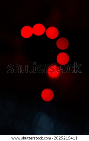 Question mark make with red light in abstract background. Neon light night discussion.