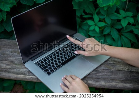 The girl behind the Silver laptop