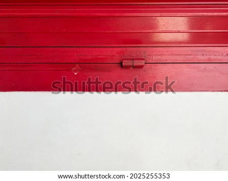 a rotated red metal door and white wall picture to resembling Indonesian flag color 