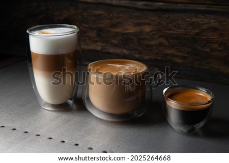 Three types of coffee, Cappuccino, Latte, espresso. On a dark background Royalty-Free Stock Photo #2025264668