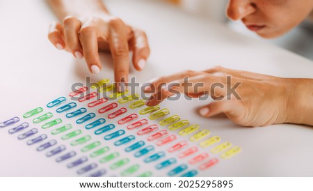 Obsessive compulsive disorder. Arranging Paperclips in a Row. Royalty-Free Stock Photo #2025295895