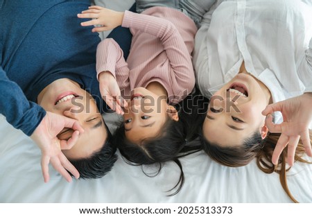 Happy family with daughters playing at home and weekend for family