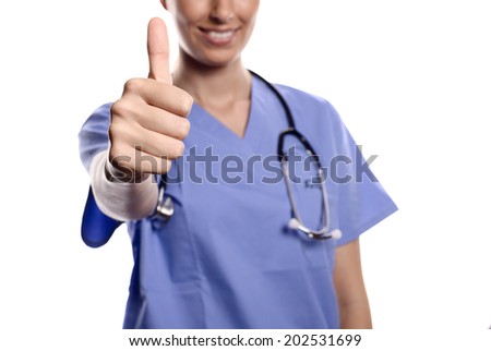 Happy woman doctor giving a thumbs up gesture to show that surgery or treatment of a patient has been successful and there is hope for a full recovery, isolated on white