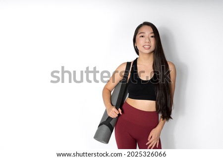 Smiling woman, sportswear against white background. Horizontal photography.