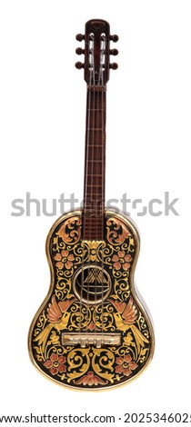 Souvenir guitar with golden ornamented isolated on white background