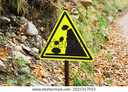Sign about the danger of rockfall in the park, nature.
