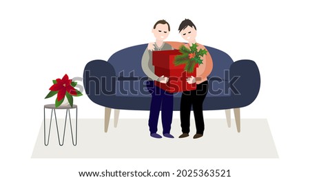 Two gay men are sitting on the couch looking at a Christmas present in a red box.
