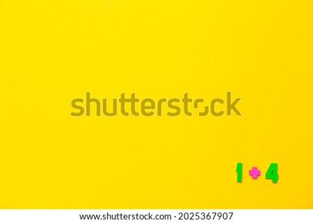 One plus four equals five is example on yellow background. Copy space. Math lesson. Primary count teaching. Online course of distance education design mockup. Flat lay. Text place. Back to school.