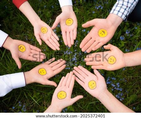 International Friends Day. Happy international friendship day. Top view of eight friends hands. The palms are turned upwards. Smilies are painted on the palms. Right hand. Emoji`s birthday Royalty-Free Stock Photo #2025372401