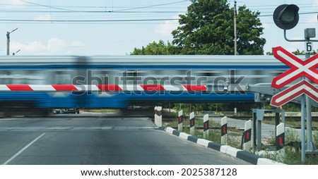 A blurry image of a train passing through an adjustable crossing