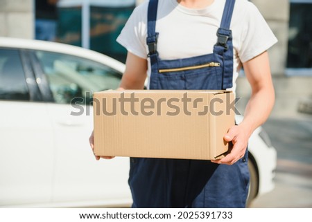 Postman with parcel box. Postal delivery service.