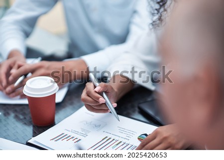 takeaway coffee on the table with financial documents. close-up.