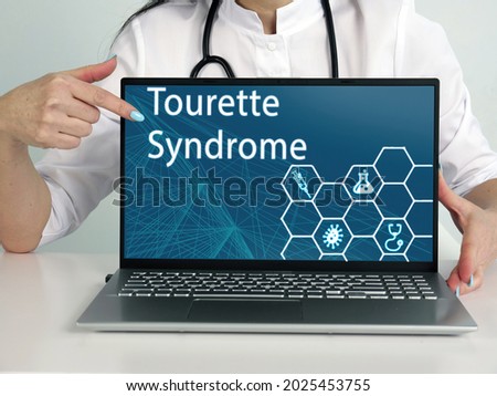  Tourette Syndrome text in menu. Neurologist looking for something at laptop
