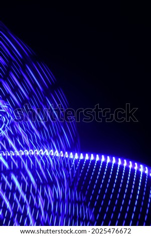 The beuatiful neon light pattern, which is white and blue, is very unique and gives an artistic impression and illustrates an electrical technology. Long Exposure Photography. Light Painting.