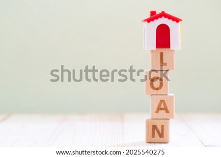 Business Word LOAN, A Wooden ABC Blocks on background with copy space using for Banking Financial Professional Service Provider Business and Housing Loan Mortgage Liability Loan guarantee concept