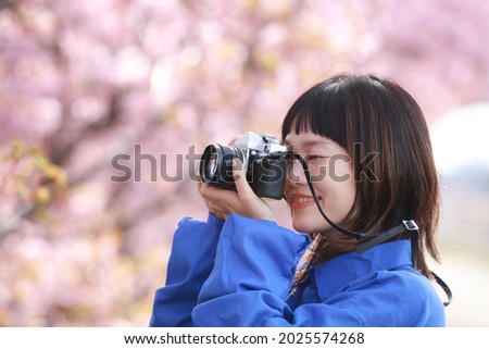 Image of a woman taking a picture 
