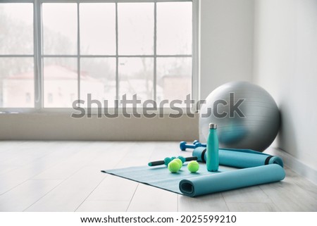 Set of sports equipment with fitness ball in gym Royalty-Free Stock Photo #2025599210