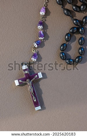 Detail of a beautiful old rosary to pray, purple or violet