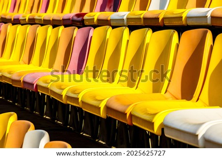 Empty plastic chairs in the stadium.
