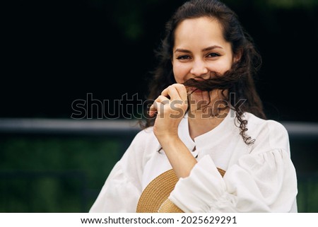 Young beautiful cheerful girl in a summer park.