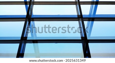 Structural glazing of wall, ceiling or roof. Minimalist architecture of modern building. Abstract material and geometric background for construction industry or technology. Parallel lines with shadows