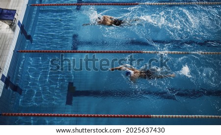 Swim Race: Two Professional Swimmers Swim in Swimming Pool, Stronger and Faster Wins. Athletes Compete the Best Wins Championship, World Record. Aerial Top Down View