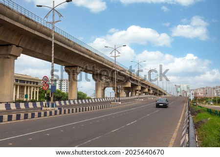 Early morning traffic on city road with view of flyover and commercial and residential buildings at Rajarhat area Kolkata Royalty-Free Stock Photo #2025640670