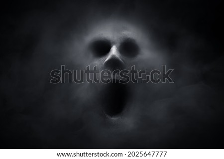 Scary ghost on dark background Royalty-Free Stock Photo #2025647777