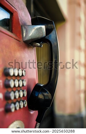 Retro payphone station for emergency call on street. Public analog pay phone booth. Outdated technology for connection and telecommunication service. Cell handset on box. Saint - Petersburg. Royalty-Free Stock Photo #2025650288