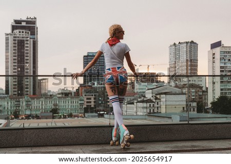 Stylish young woman with vintage roller skates in the city