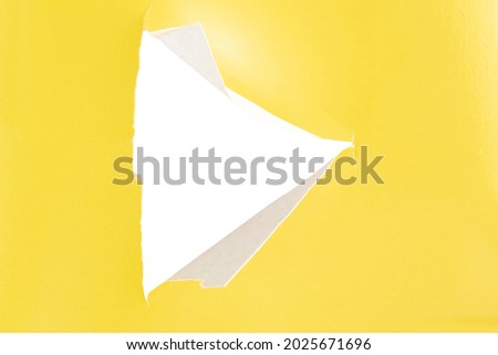 Yellow paper with a cut triangle in the middle.