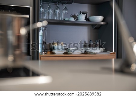 Shelves and storage areas for dishes, glasses and kitchen utensils