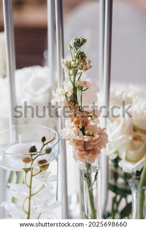 Romantic Wedding Table Top Layout Decor with large lush floral bouquets including white roses, ranunculus, persian buttercups, white orchids and candles. High quality photo